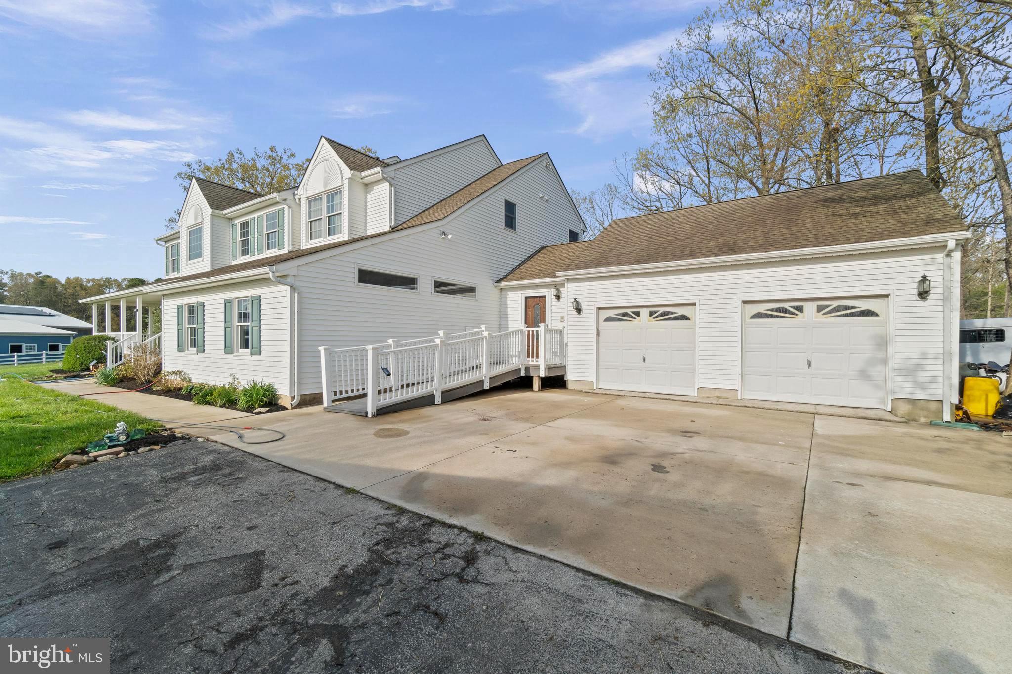24 Oriental Road Shamong, NJ 08088 - Photo 6 of 67 a view of a white house with a road and garage