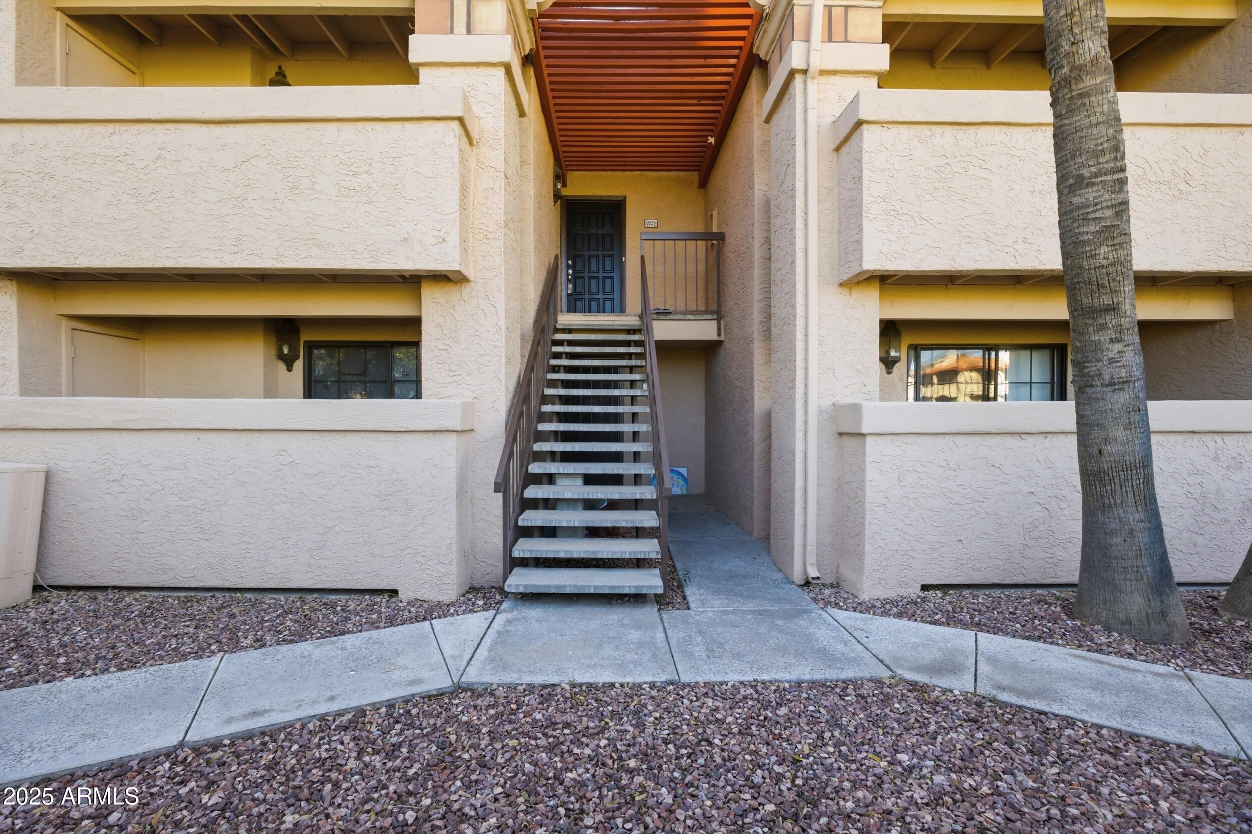10410 North Cave Creek Road, Unit 2027 Phoenix, AZ 85020 - Photo 1 of 28 a view of a brick house with a window and stairs