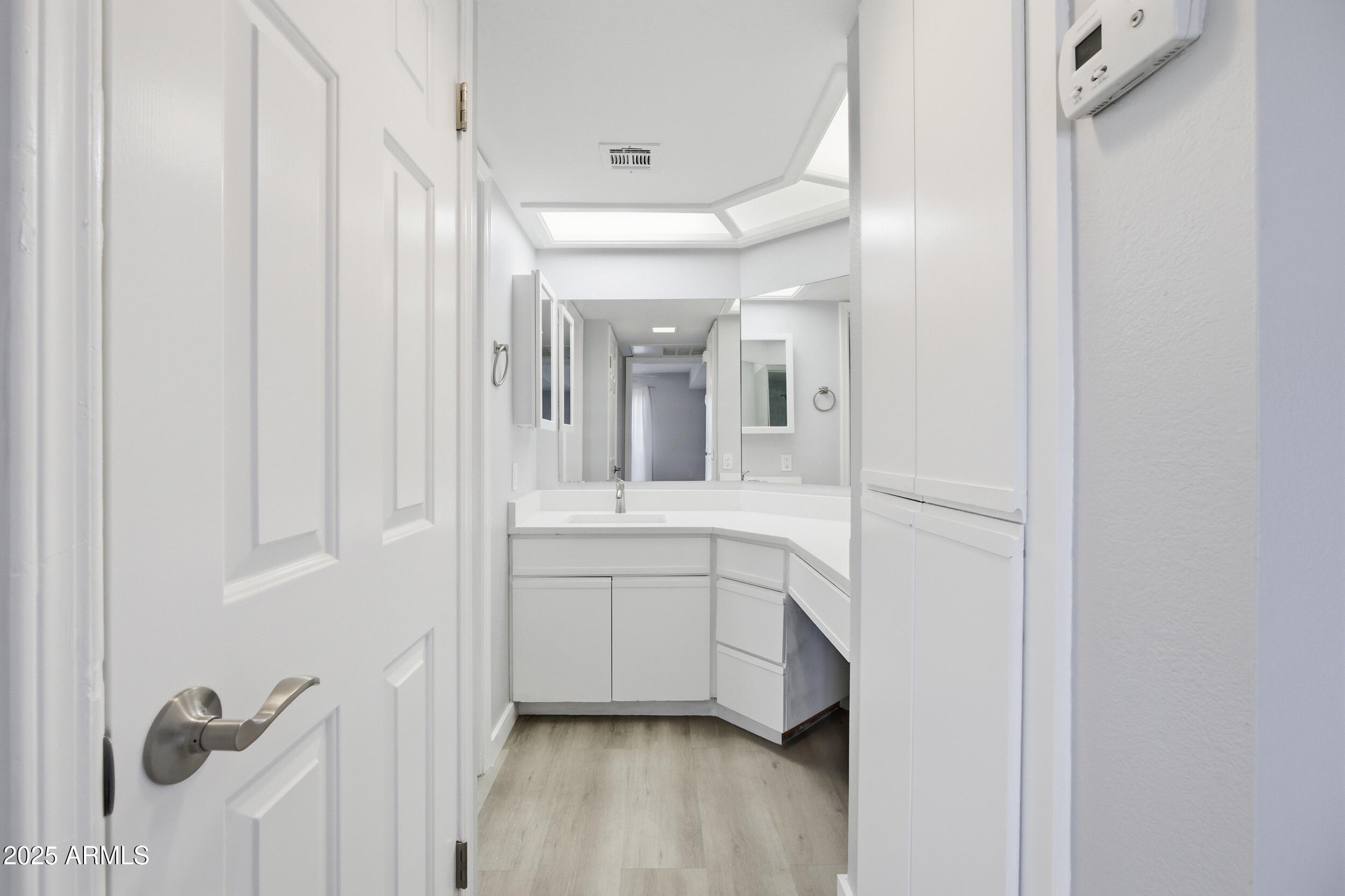 10410 North Cave Creek Road, Unit 2027 Phoenix, AZ 85020 - Photo 13 of 28 a bathroom with a double vanity sink a mirror and shower