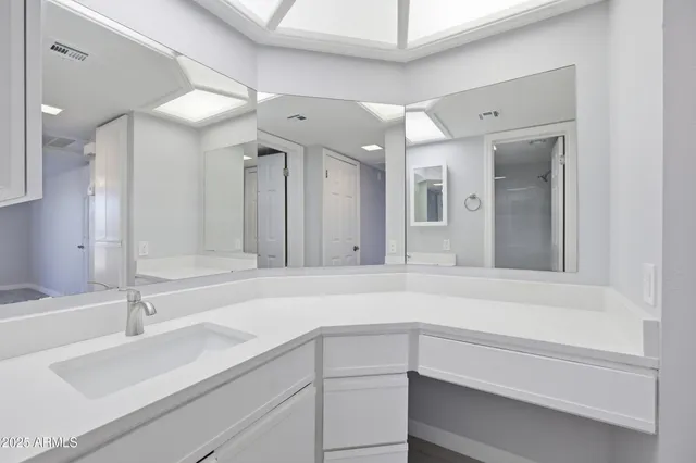 a bathroom with a double vanity sink a mirror and shower