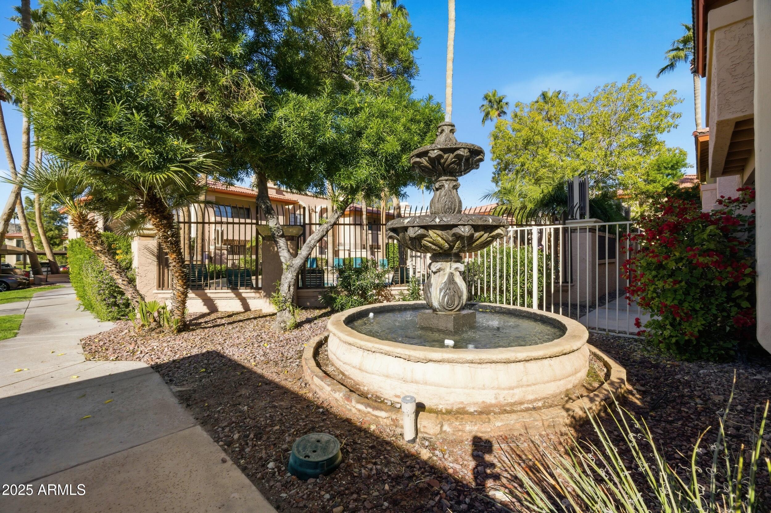10410 North Cave Creek Road, Unit 2027 Phoenix, AZ 85020 - Photo 21 of 28 a view of a patio with table and chairs potted plants and palm tree