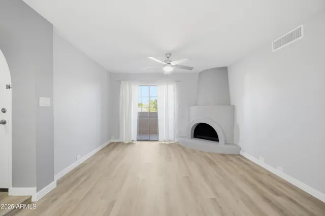 a view of empty room with fireplace