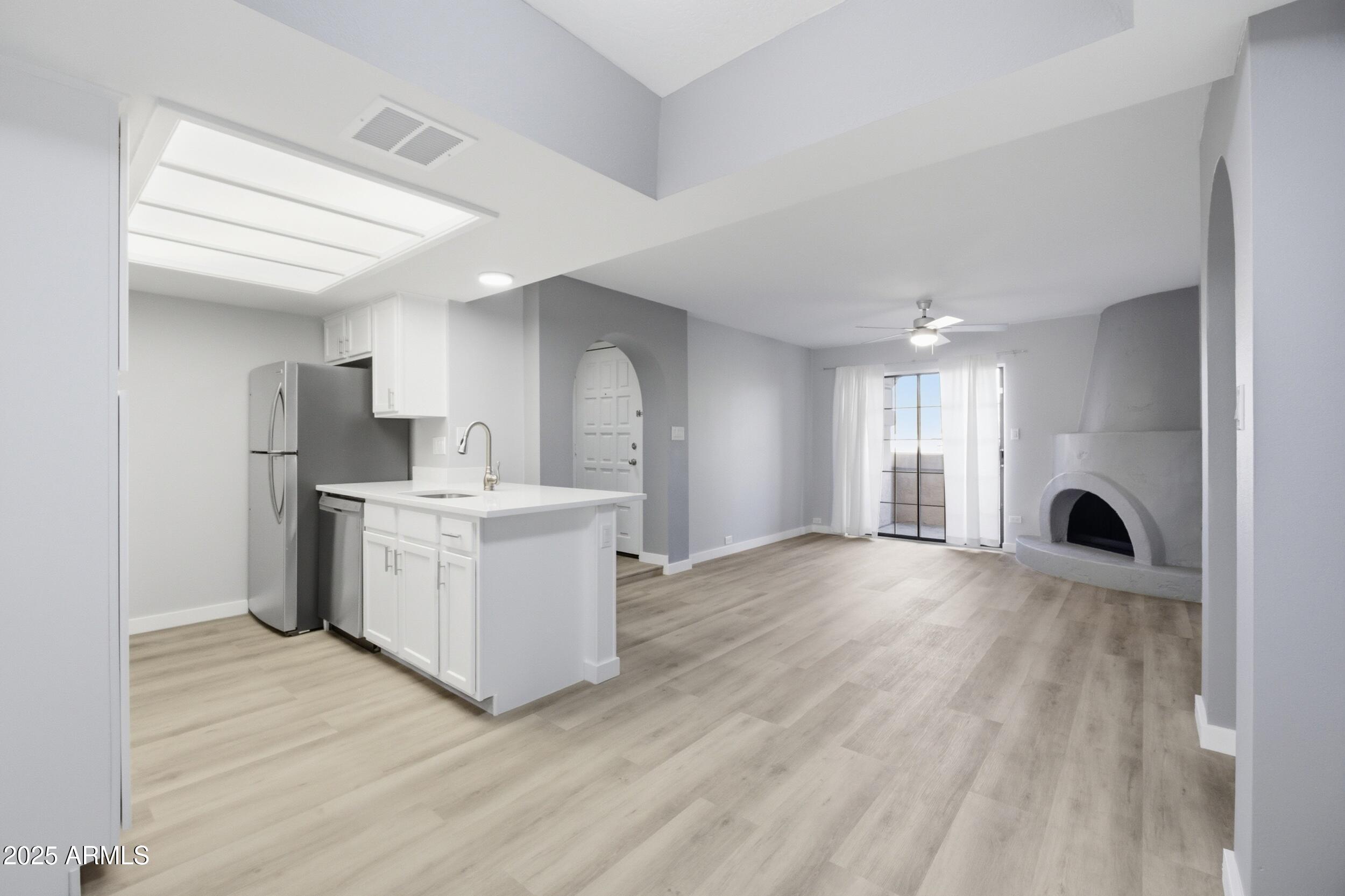10410 North Cave Creek Road, Unit 2027 Phoenix, AZ 85020 - Photo 5 of 28 a view of a kitchen with a sink and a refrigerator