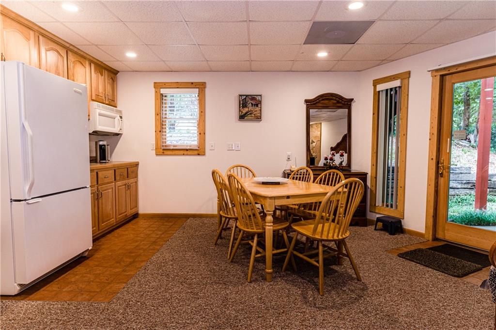 15 Alm Strasse Helen, GA 30545 - Photo 29 of 71 a dining room with furniture and a refrigerator