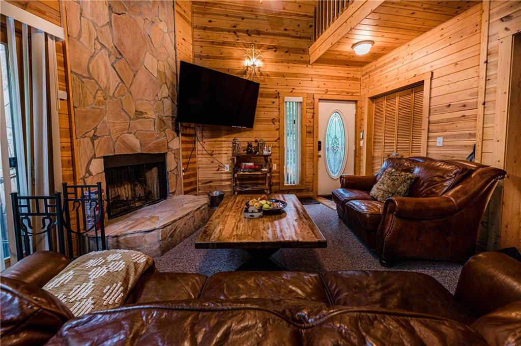15 Alm Strasse Helen, GA 30545 - Photo 38 of 71 a living room with furniture a fireplace and a flat screen tv