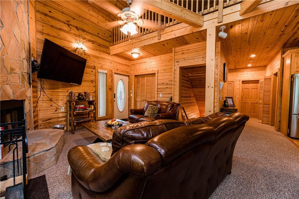 15 Alm Strasse Helen, GA 30545 - Photo 39 of 71 a living room with furniture a flat screen tv and a fireplace