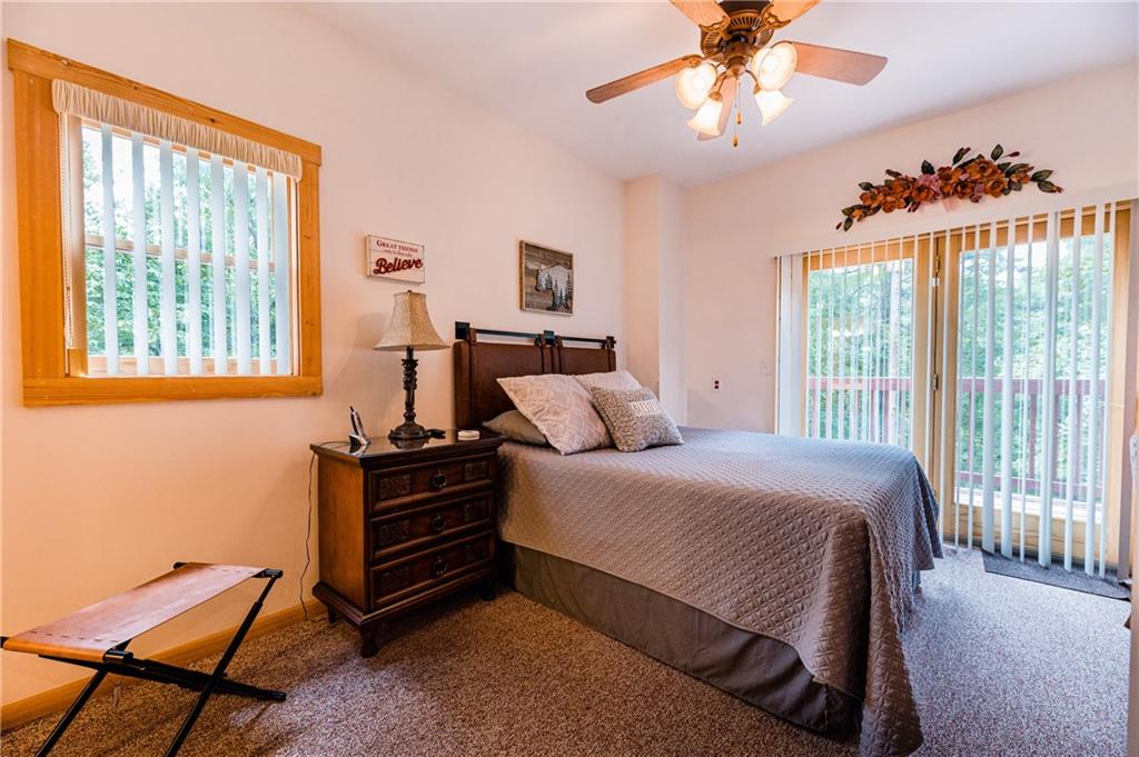 15 Alm Strasse Helen, GA 30545 - Photo 50 of 71 a bedroom with a bed and a chandelier