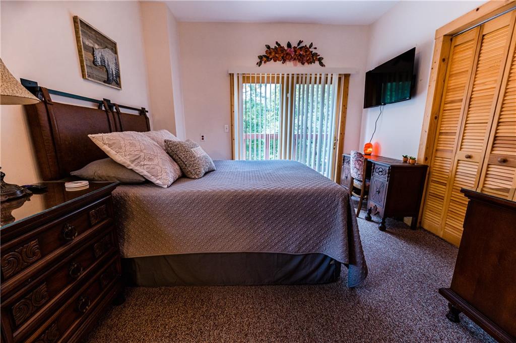 15 Alm Strasse Helen, GA 30545 - Photo 51 of 71 a bedroom with a bed tv and a window