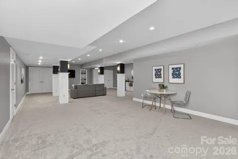 a living room with furniture and a dining table with wooden floor