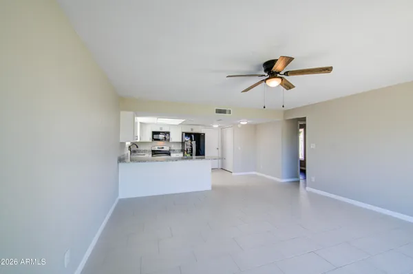 a view of a livingroom with a kitchen and a sink