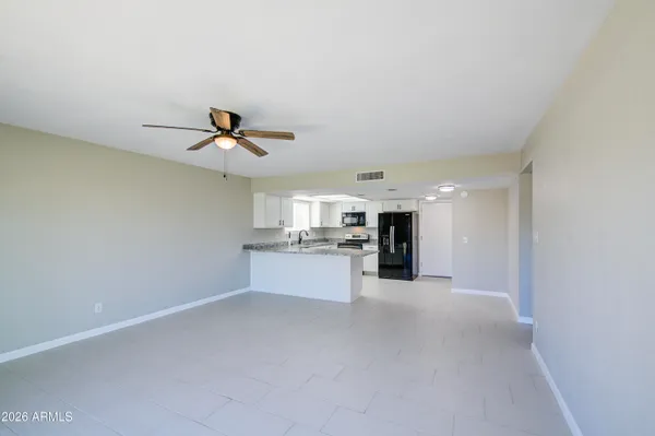 a view of a kitchen with a sink and a ceiling fan