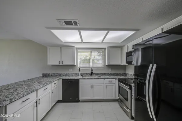 a kitchen with a sink stove and refrigerator