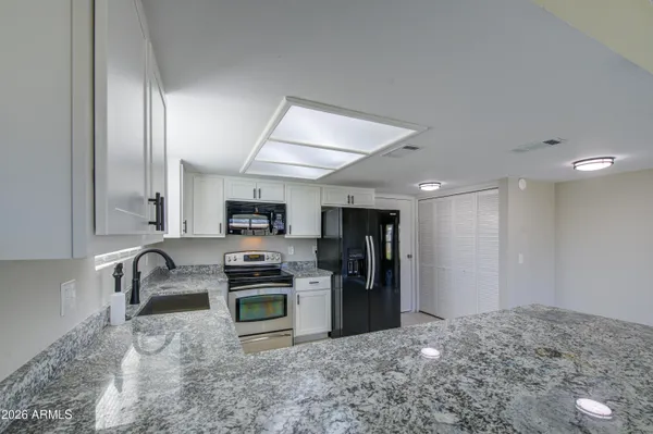 a kitchen with refrigerator and microwave