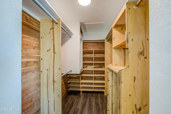 a view of walk in closet with empty racks