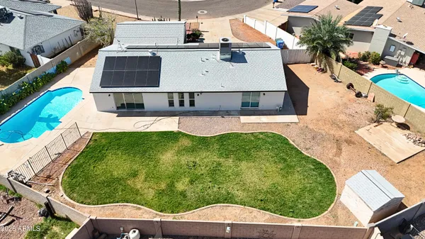 an aerial view of a house with a yard
