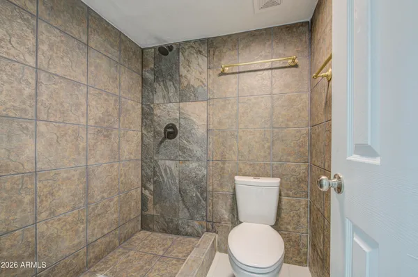 a white toilet sitting next to a bathroom