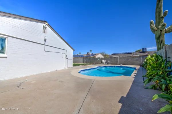 a view of a swimming pool with a yard
