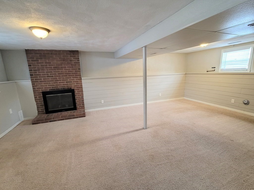 4 Allen Road Billerica, MA 01821 - Photo 13 of 24 a view of an empty room with a fireplace and a window