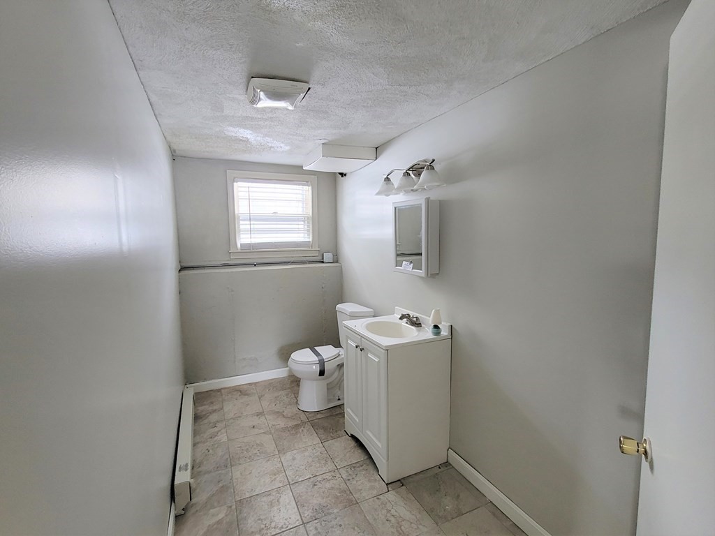 4 Allen Road Billerica, MA 01821 - Photo 15 of 24 a bathroom with a toilet sink and mirror