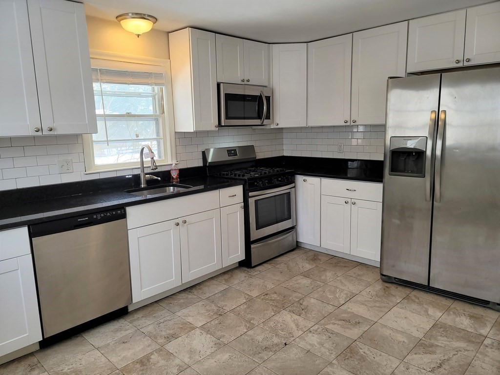 4 Allen Road Billerica, MA 01821 - Photo 3 of 24 a kitchen with cabinets stainless steel appliances a sink and a window