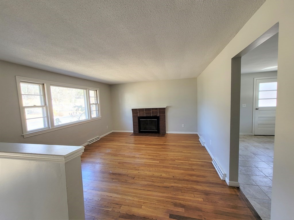 4 Allen Road Billerica, MA 01821 - Photo 5 of 24 a view of empty room with wooden floor and window