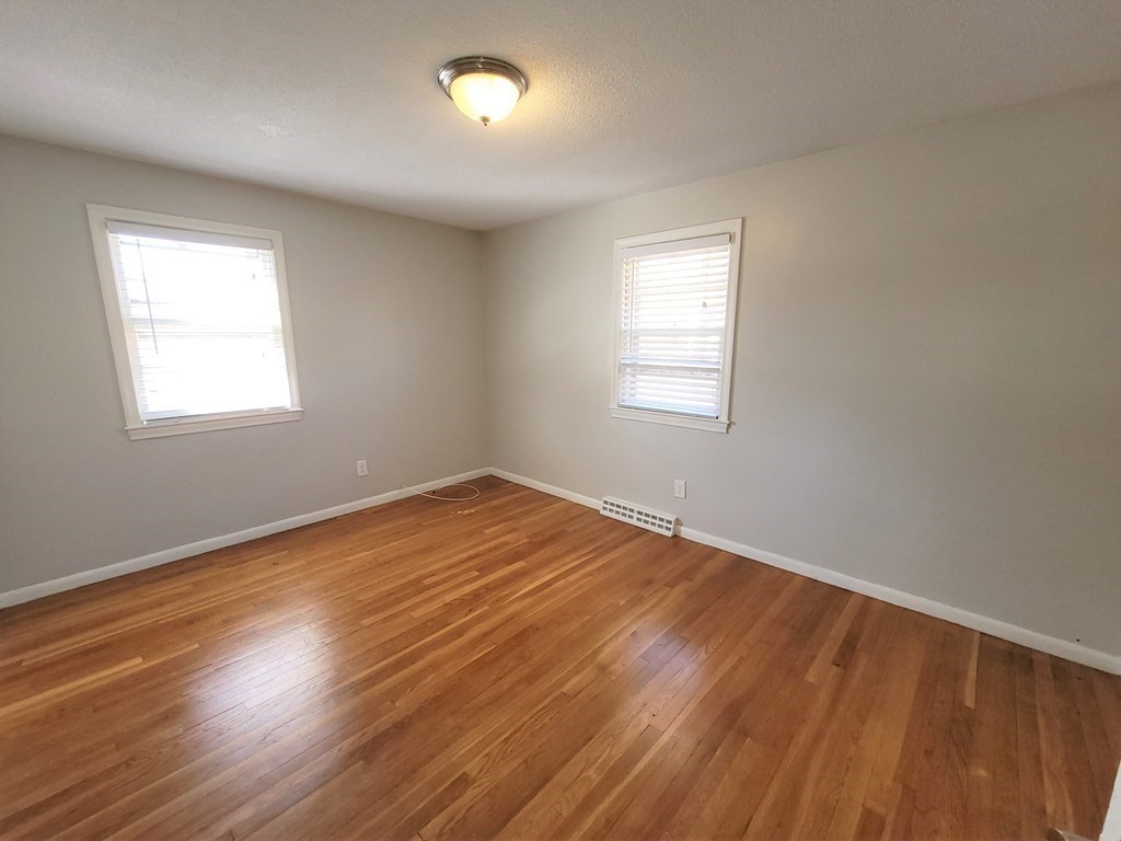 4 Allen Road Billerica, MA 01821 - Photo 8 of 24 an empty room with wooden floor and windows