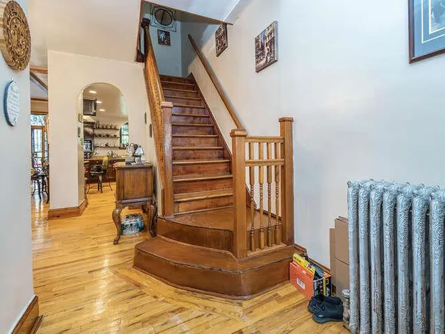 a view of entryway and hall with wooden floor