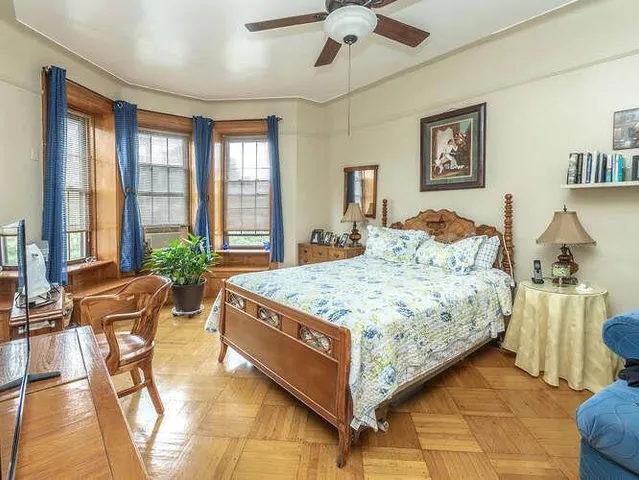 a bedroom with a large bed and a chandelier