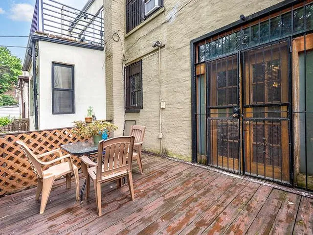 a view of a patio with table and chairs and potted plants