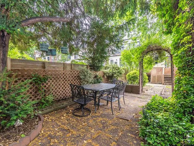 a view of a table and chairs in the garden