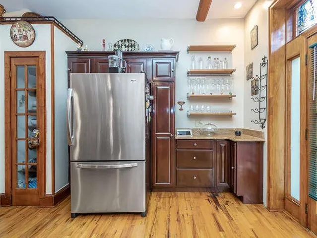 a kitchen with stainless steel appliances granite countertop a refrigerator and a stove