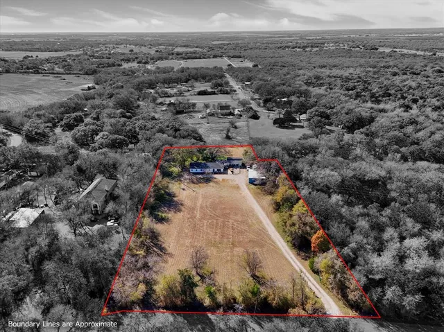 an aerial view of a residential houses with outdoor space
