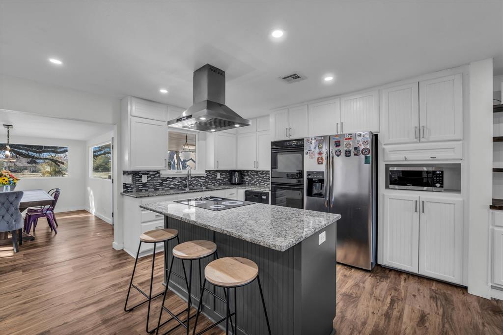 1835 Ft Graham Road Waco, TX 76705 - Photo 11 of 40 a kitchen with stainless steel appliances granite countertop a table chairs stove and refrigerator
