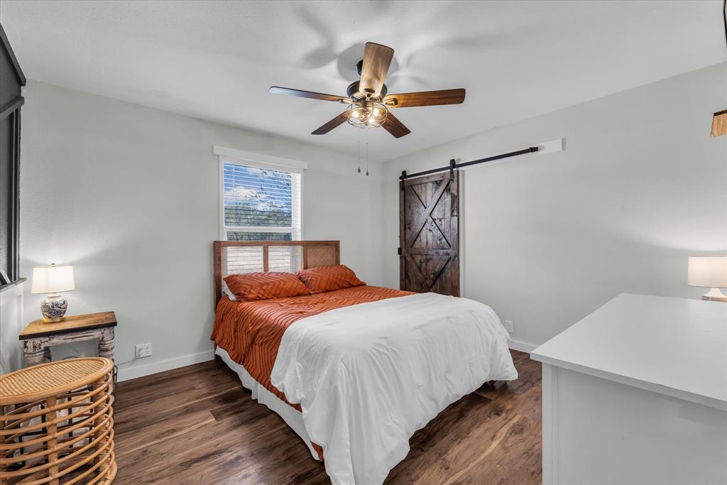 1835 Ft Graham Road Waco, TX 76705 - Photo 17 of 40 a bedroom with a bed and a chandelier