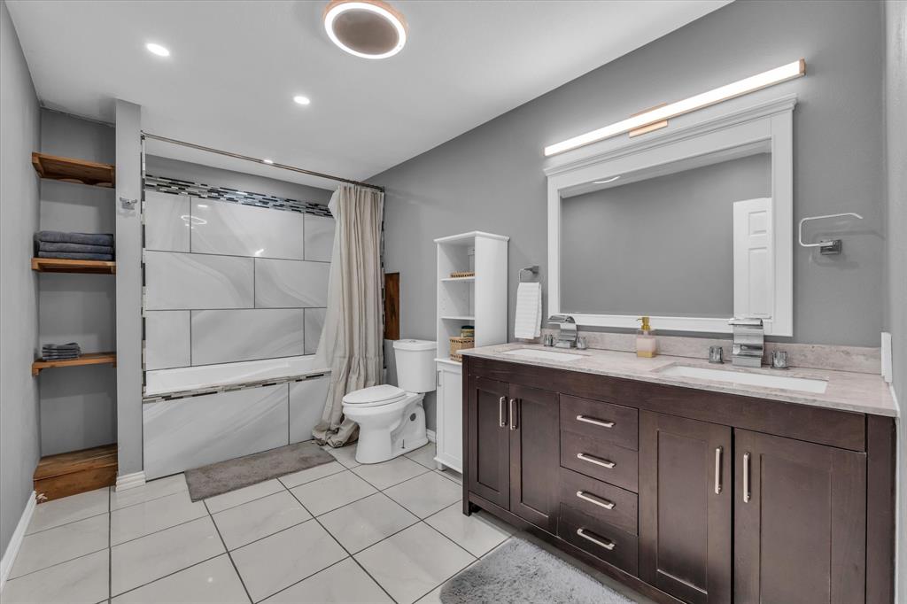 1835 Ft Graham Road Waco, TX 76705 - Photo 18 of 40 a bathroom with a double vanity sink mirror and shower