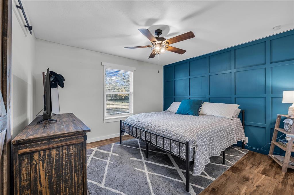 1835 Ft Graham Road Waco, TX 76705 - Photo 19 of 40 a bedroom with a bed and a table in it