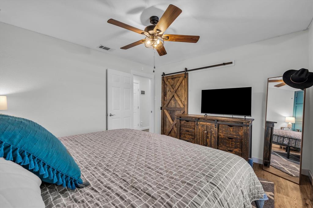 1835 Ft Graham Road Waco, TX 76705 - Photo 20 of 40 a bedroom with a bed and a flat screen tv