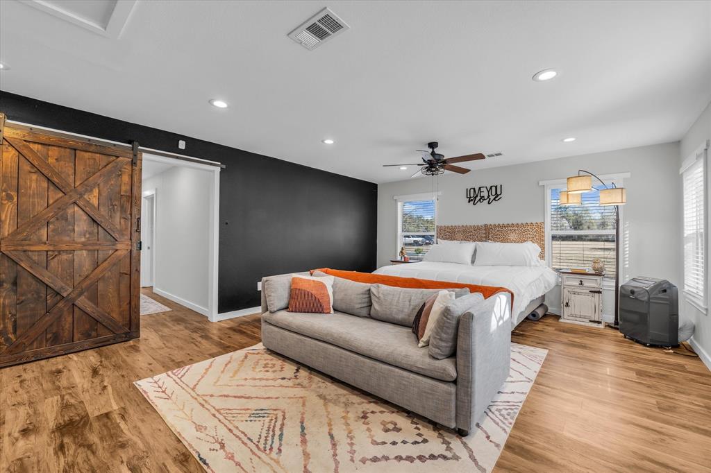 1835 Ft Graham Road Waco, TX 76705 - Photo 23 of 40 a bedroom with a large bed and a couch