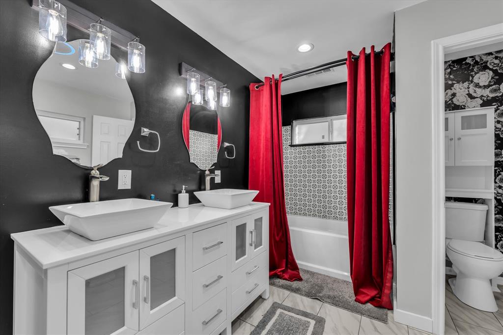 1835 Ft Graham Road Waco, TX 76705 - Photo 26 of 40 a bathroom with a sink vanity mirror and toilet