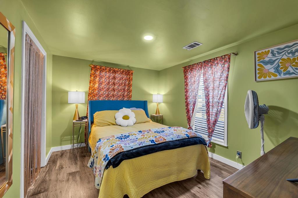 1835 Ft Graham Road Waco, TX 76705 - Photo 29 of 40 a bedroom with a bed and wooden floor