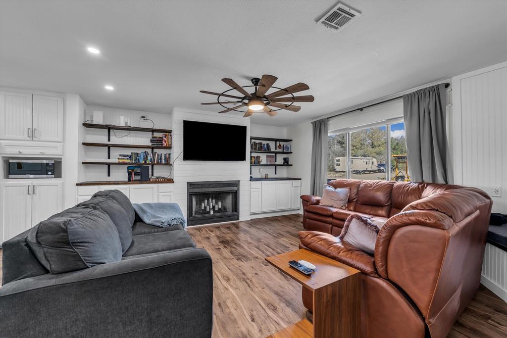1835 Ft Graham Road Waco, TX 76705 - Photo 8 of 40 a living room with furniture a fireplace and a flat screen tv
