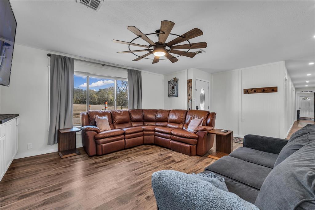 1835 Ft Graham Road Waco, TX 76705 - Photo 9 of 40 a living room with furniture a ceiling fan a window and a fan