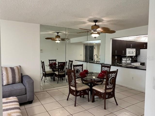 23465 Harbor View Road, Unit 1006 Punta Gorda, FL 33980 - Photo 9 of 41 a view of a dining room with furniture and chandelier