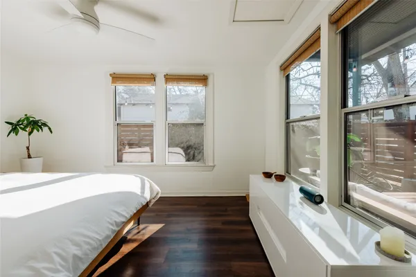 a spacious bedroom with a large bed and a large window