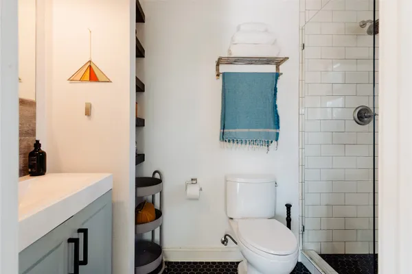 a bathroom with a toilet a sink and mirror