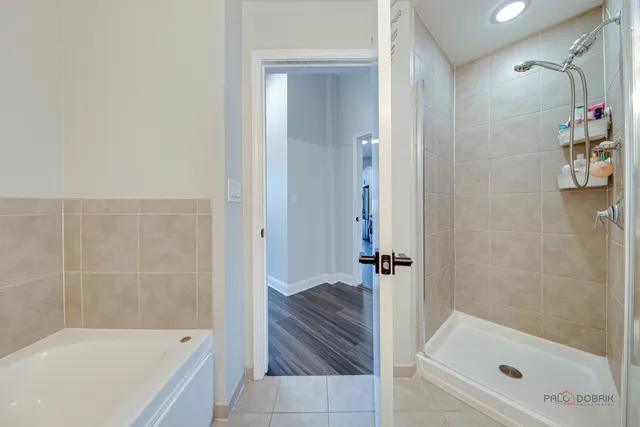 a bathroom with a tub sink and mirror