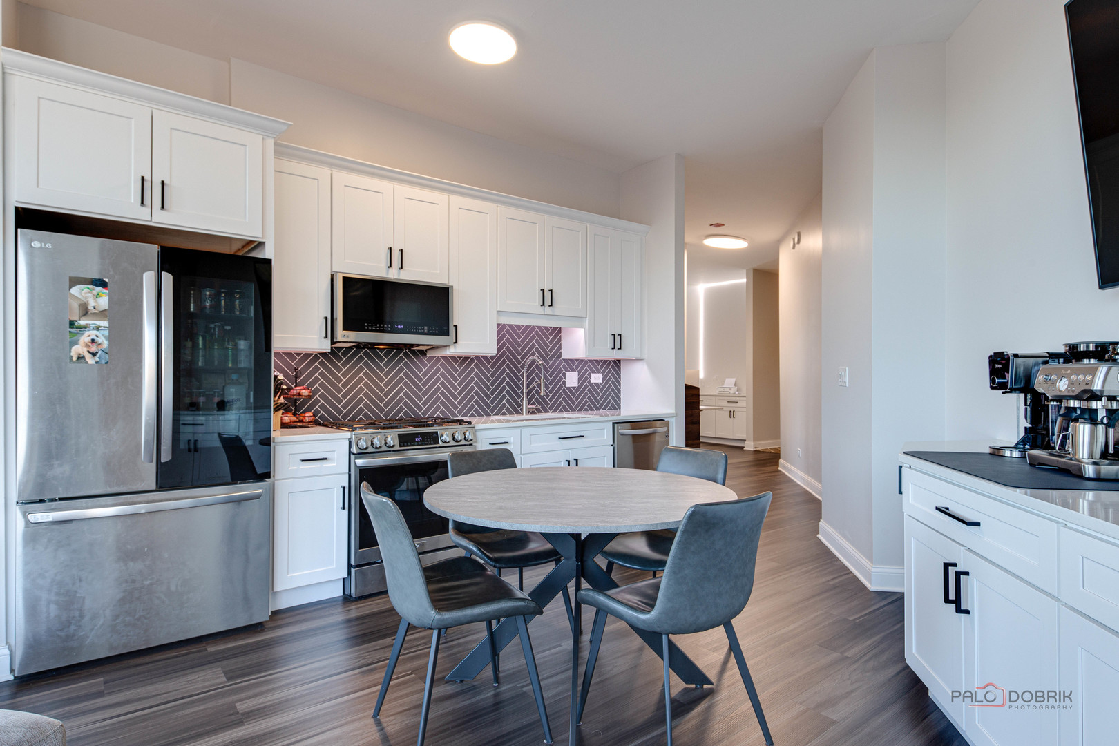 1600 South Indiana Avenue, Unit 803 Chicago, IL 60616 - Photo 7 of 24 a kitchen with stainless steel appliances a dining table chairs refrigerator and sink
