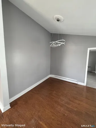 a view of a room with wooden floor