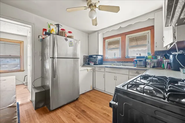 a kitchen with a refrigerator stove and sink