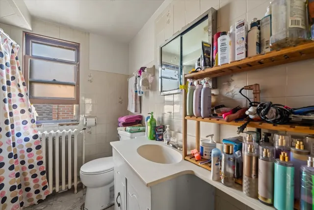 a bathroom with a toilet a sink and a window